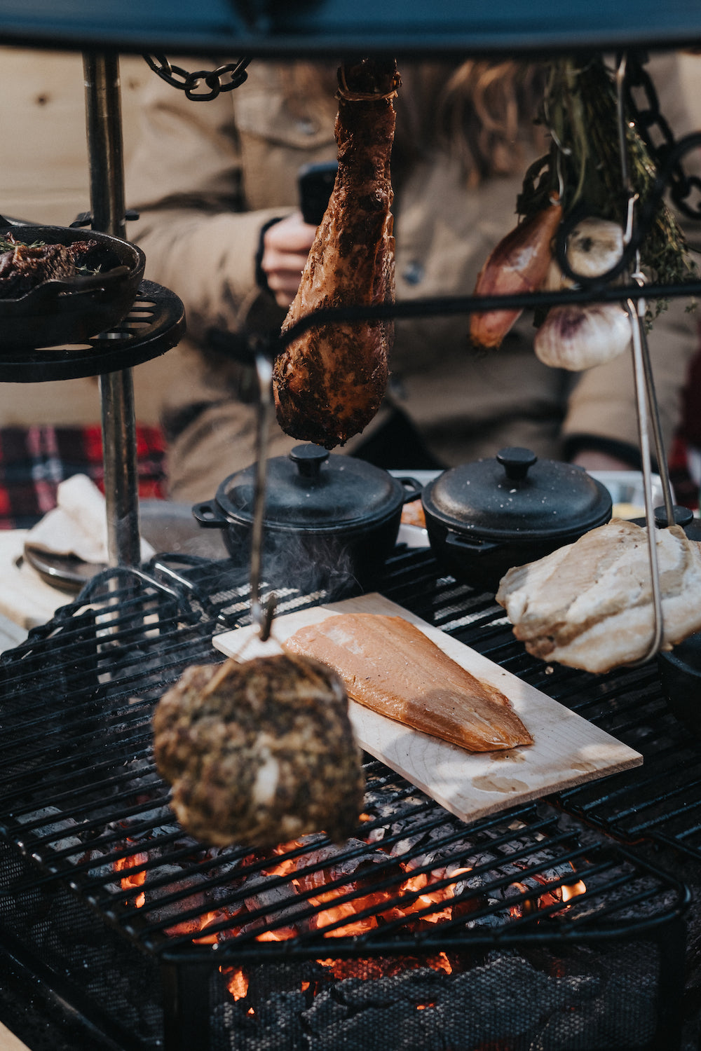      An assortment of grill accessories on the Kota Grill, each with their own meal cooking.  