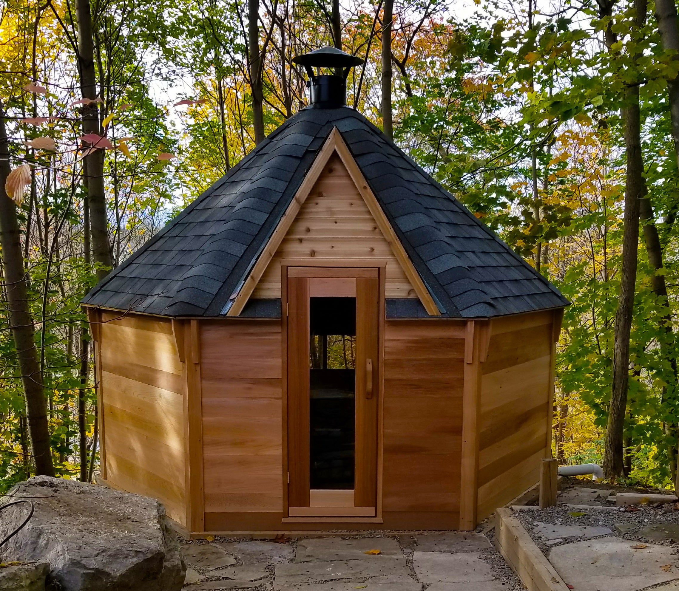       A Kota Cabin sits in a wooded area. 