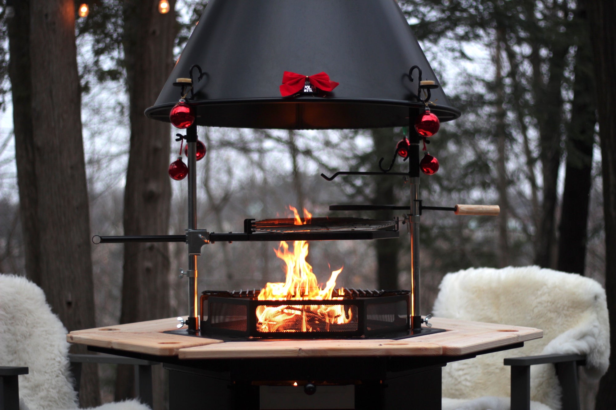   A Winder Celebration themed Kota Grill adorned with a bow and decorations while a fire burns surrounded by sheepskin covered chairs.    