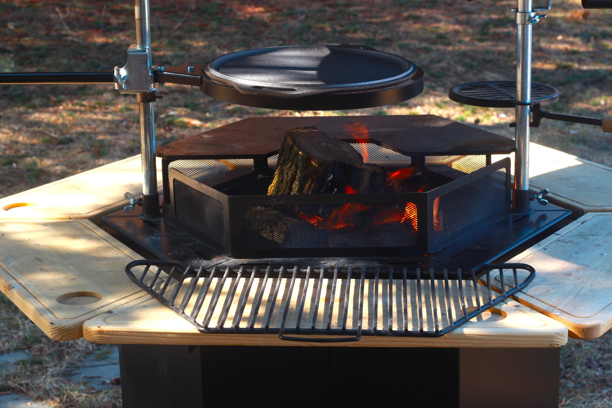      A woodfire burns in a Kota Grill with all the Kota Accessories. 